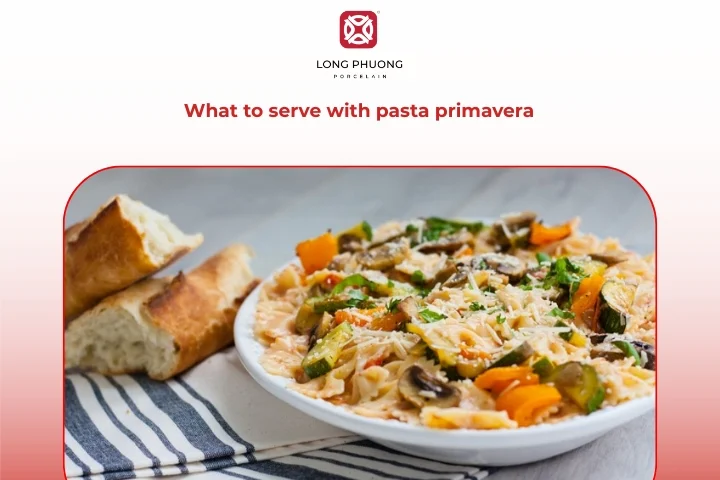 Pasta primavera served with salad and garlic bread on porcelain plates