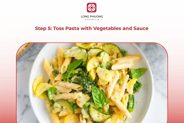 Tossing pasta with creamy pasta vegetables in large pan